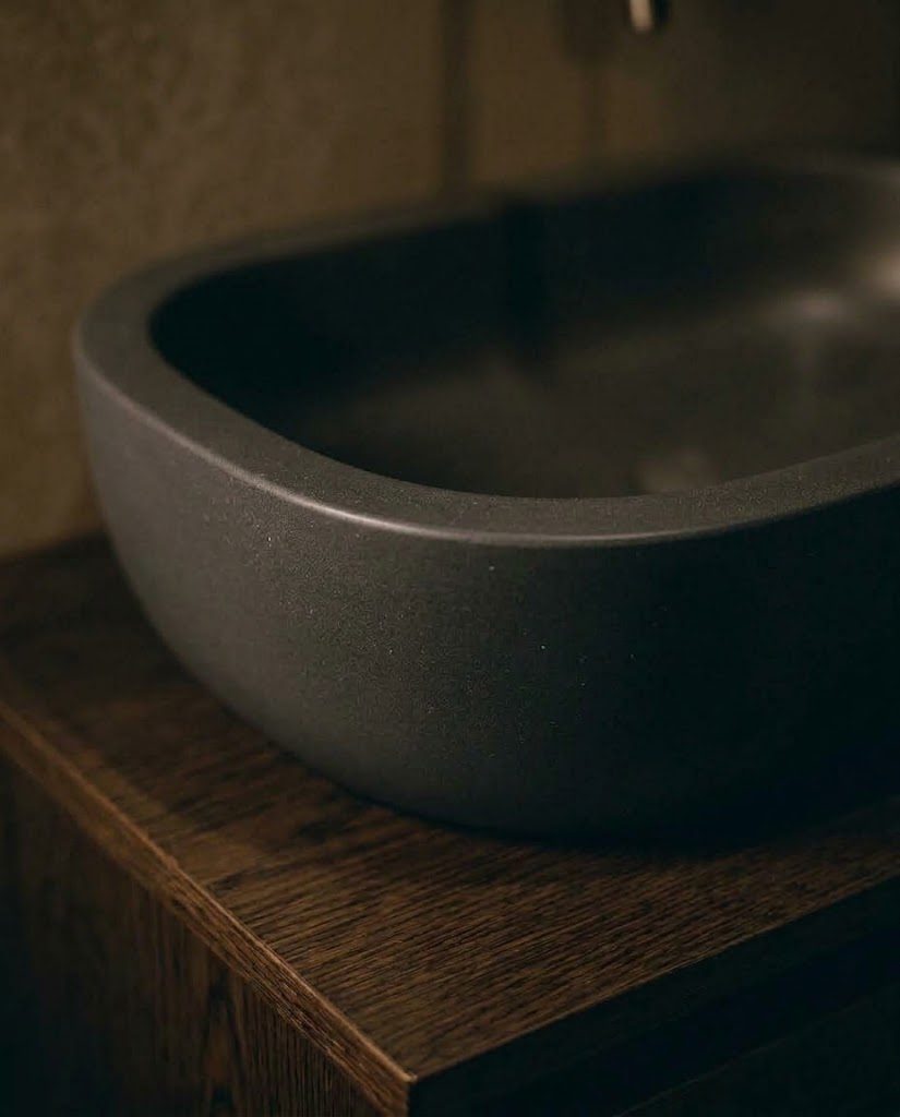 Charcoal vessel basin on a dark wood vanity