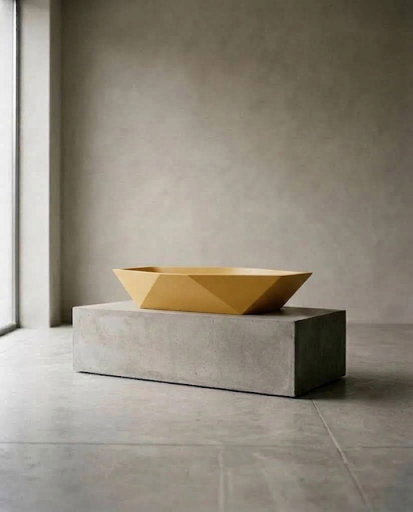 Mustard faceted CB custom basin on a concrete plinth